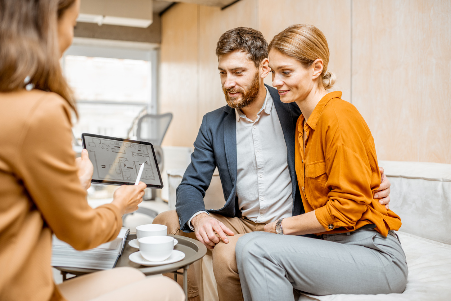 Young Couple Choosing House at the Real Estate Agency
